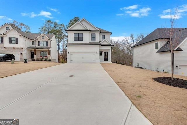 view of front of home with board and batten siding, an attached garage, and concrete driveway