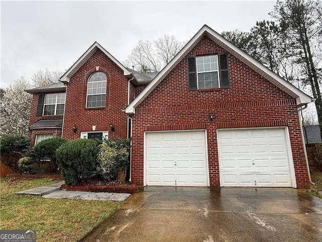 view of front of house featuring a garage, brick siding, and driveway