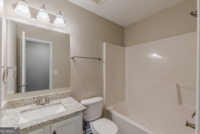 bathroom with toilet, shower / bathtub combination, vanity, and a textured ceiling