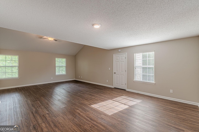 interior space with baseboards, dark wood finished floors, ceiling fan, and a textured ceiling