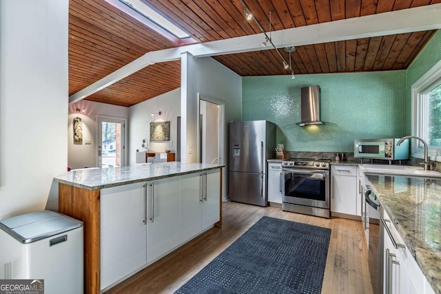 kitchen with stainless steel appliances, wall chimney exhaust hood, wooden ceiling, white cabinetry, and light stone countertops