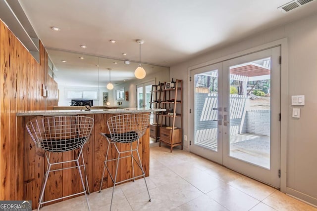 bar with french doors, light tile patterned floors, pendant lighting, and recessed lighting