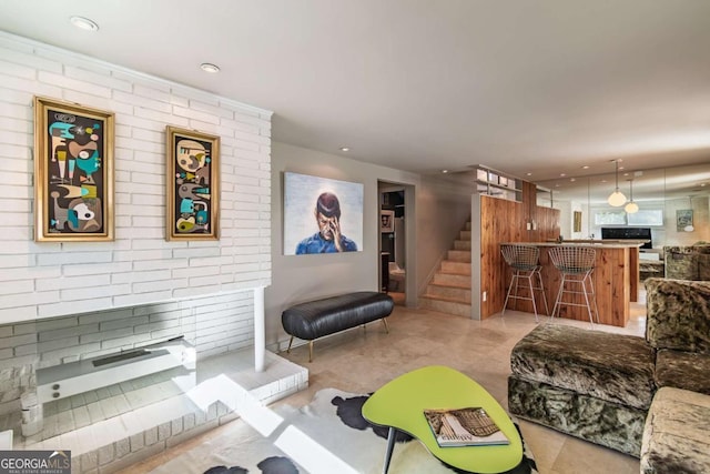 living area featuring stairway, a fireplace, and recessed lighting