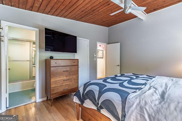 bedroom with wood ceiling, wood finished floors, ensuite bathroom, and ceiling fan