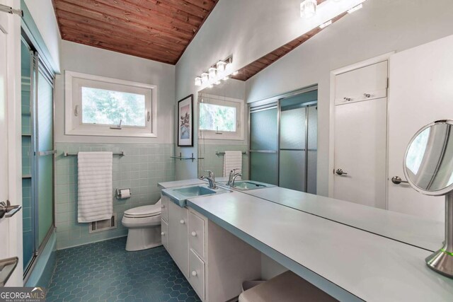 full bath featuring wood ceiling, tile patterned flooring, toilet, tile walls, and vanity