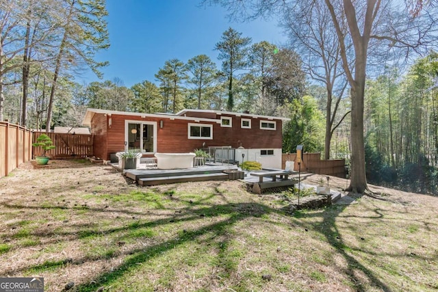 back of house with a deck