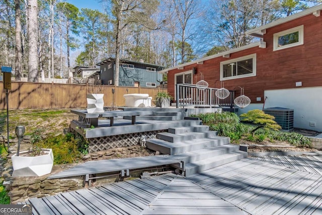 wooden deck with cooling unit and stairway