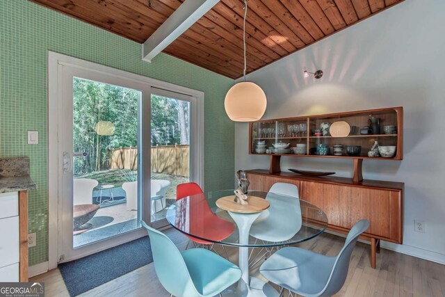 dining room featuring wood ceiling, wood finished floors, baseboards, and wallpapered walls