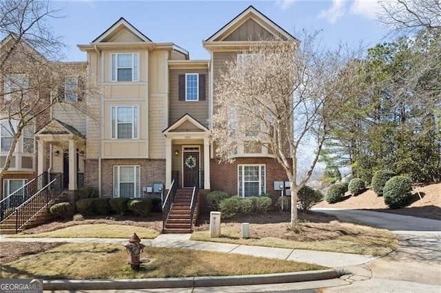 townhome / multi-family property featuring brick siding and concrete driveway