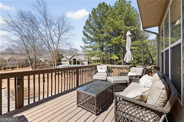 wooden deck with an outdoor living space and a residential view