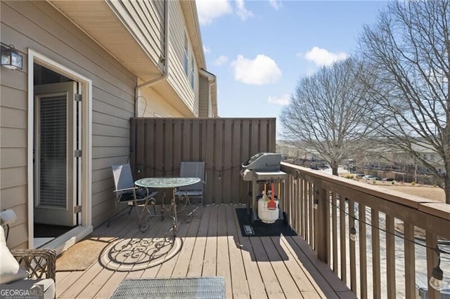 wooden deck featuring a grill