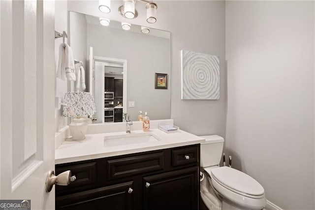 bathroom with toilet and vanity