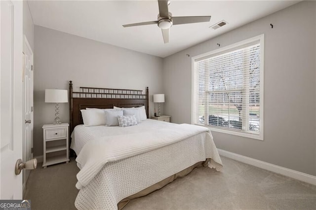 bedroom featuring visible vents, carpet floors, baseboards, and a ceiling fan