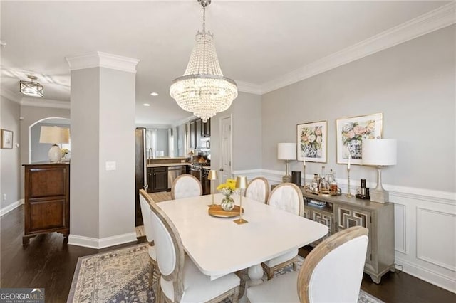 dining area featuring crown molding, a notable chandelier, and dark wood-style floors