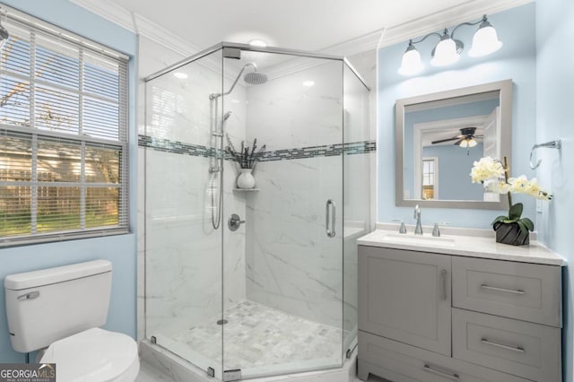 full bathroom with vanity, a marble finish shower, ceiling fan, crown molding, and toilet