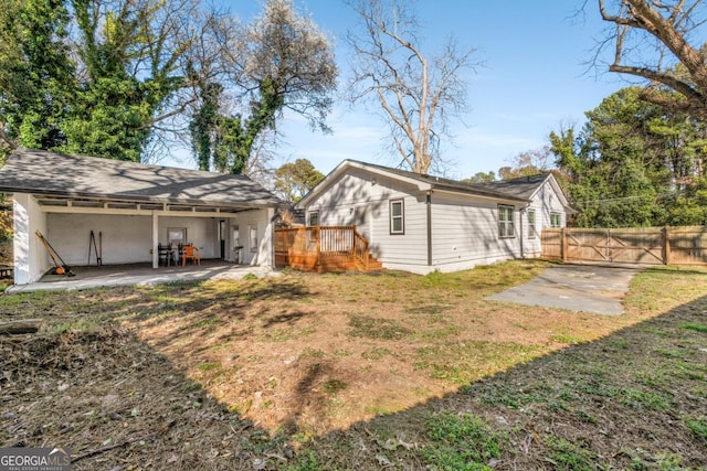 rear view of house with a patio area, a yard, and fence