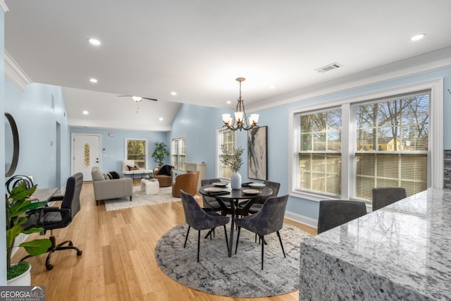 dining room featuring light wood-type flooring, visible vents, and ornamental molding