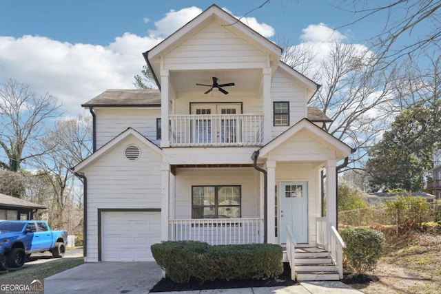 view of front facade with driveway, a ceiling fan, covered porch, a garage, and a balcony