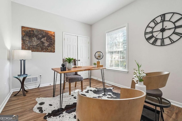 office with visible vents, baseboards, and wood finished floors