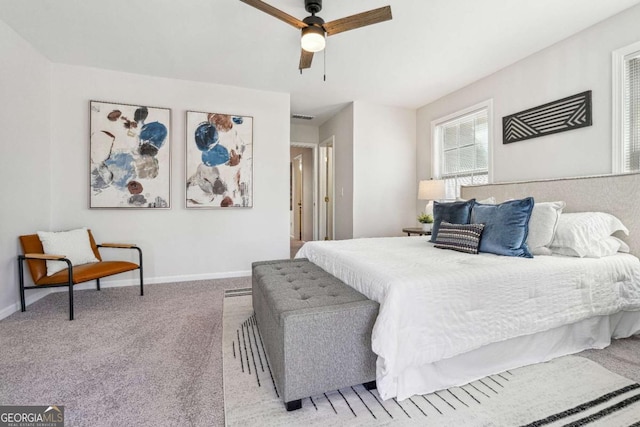 carpeted bedroom featuring baseboards and a ceiling fan