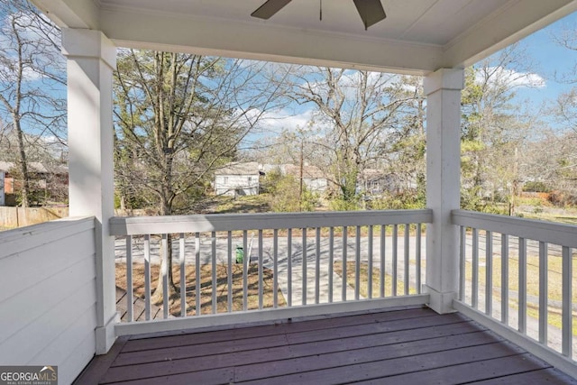 wooden deck with a ceiling fan