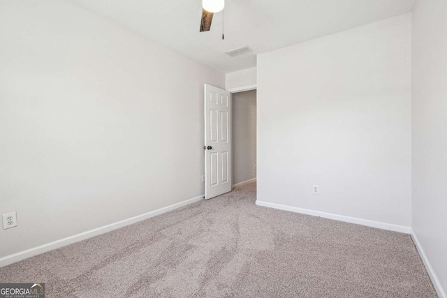 unfurnished room featuring visible vents, light carpet, baseboards, and ceiling fan