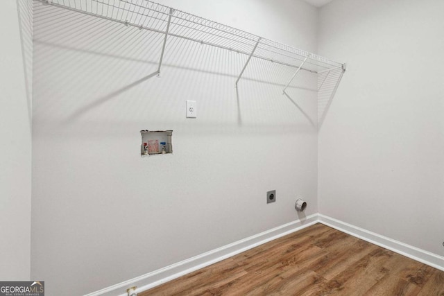 clothes washing area with wood finished floors, baseboards, laundry area, electric dryer hookup, and washer hookup