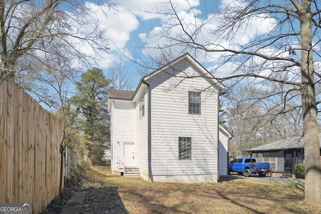 view of home's exterior with fence and entry steps