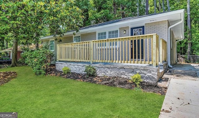 view of front of property with brick siding and a front lawn