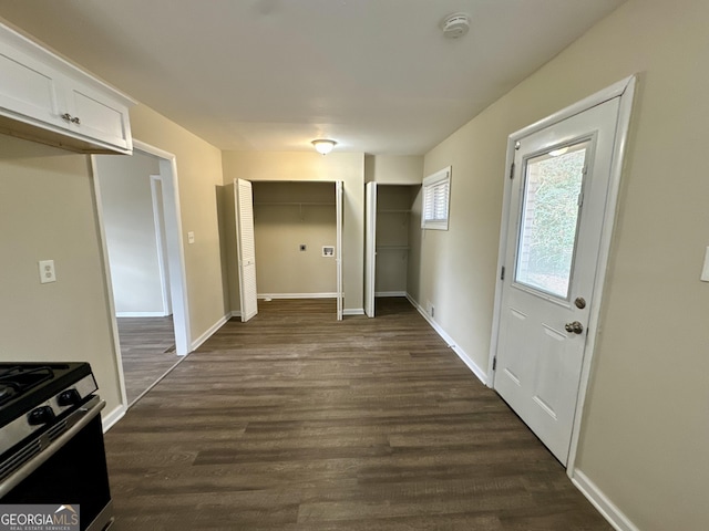 interior space featuring dark wood-style floors and baseboards