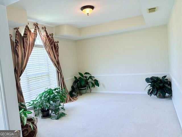 sitting room with visible vents and carpet floors