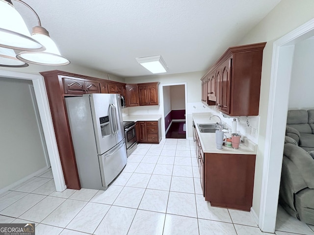 kitchen featuring fridge with ice dispenser, stainless steel range with electric stovetop, a sink, light countertops, and light tile patterned floors