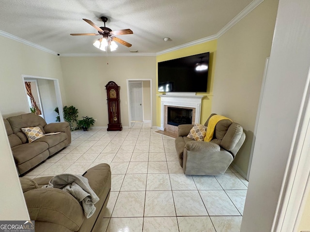 living area featuring a ceiling fan, light tile patterned flooring, crown molding, and a tiled fireplace