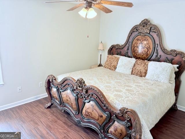 bedroom featuring a ceiling fan, wood finished floors, and baseboards