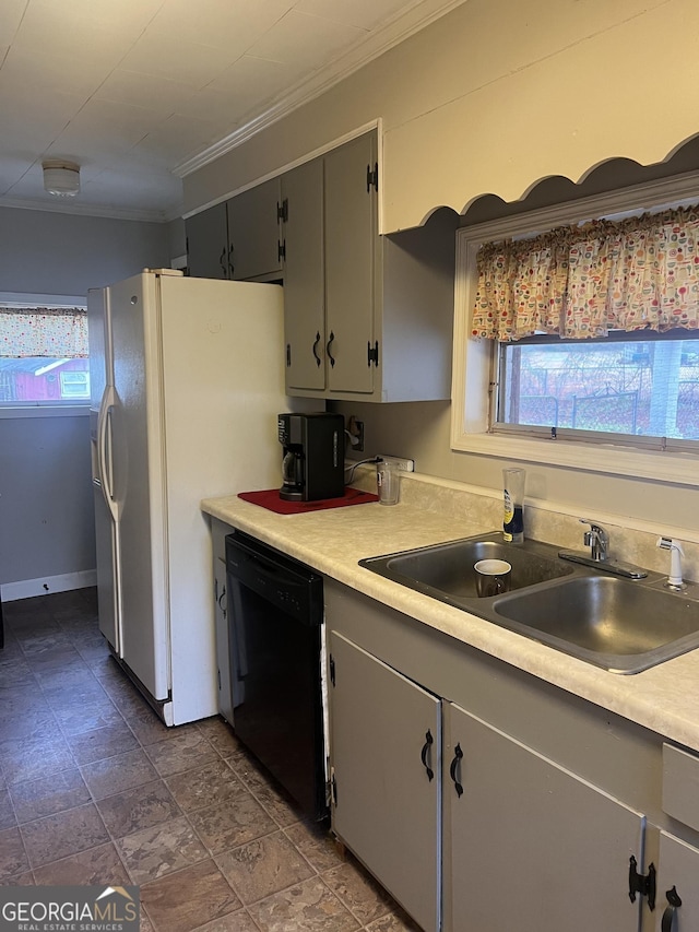 kitchen featuring dishwasher, light countertops, ornamental molding, and a sink