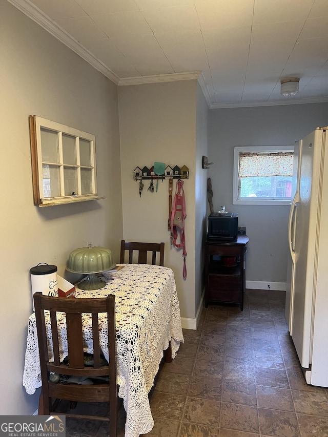 bedroom featuring crown molding, freestanding refrigerator, and baseboards