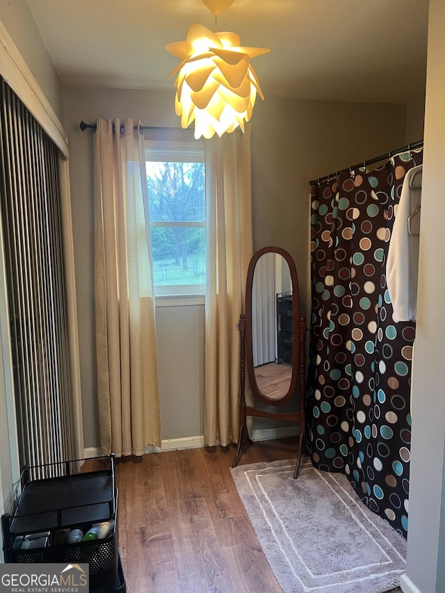 interior space featuring wood finished floors and baseboards