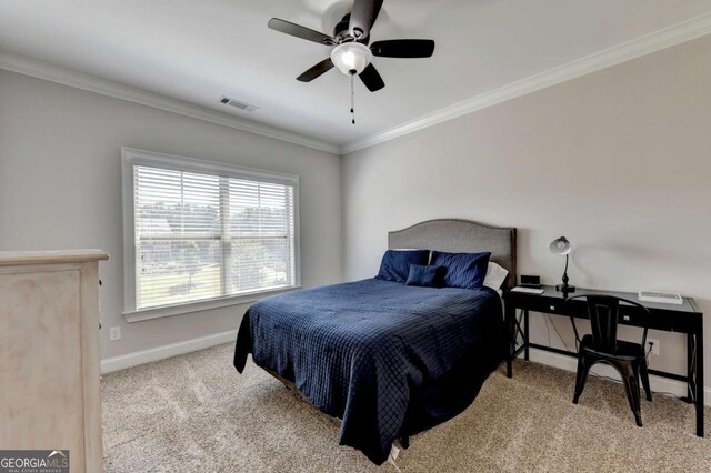 carpeted bedroom featuring a ceiling fan, baseboards, visible vents, and ornamental molding