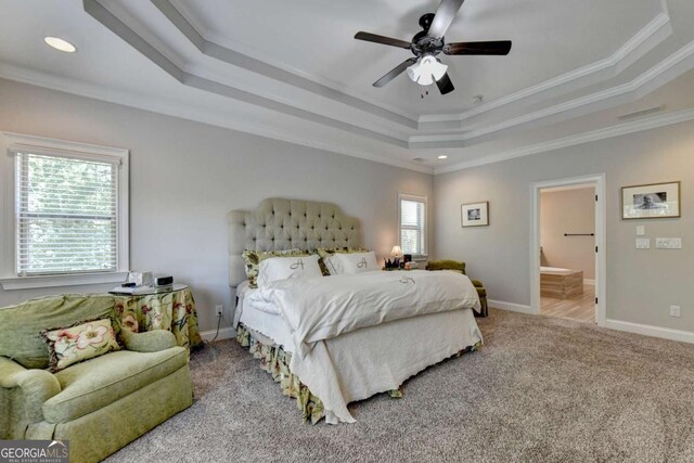 bedroom with crown molding, ceiling fan, baseboards, a tray ceiling, and carpet flooring