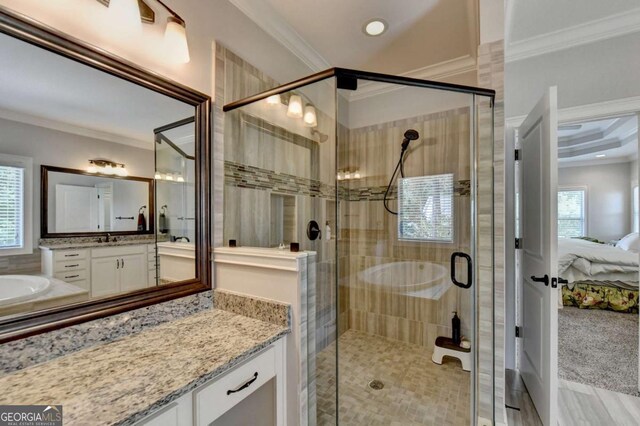 ensuite bathroom with a shower stall, ensuite bath, vanity, and ornamental molding