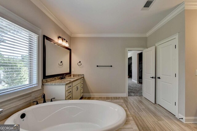 full bathroom featuring visible vents, a bath, vanity, and ornamental molding