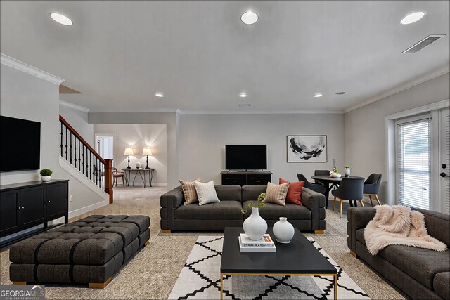 interior space with visible vents, baseboards, light colored carpet, and stairway