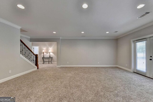 basement featuring visible vents, baseboards, and ornamental molding