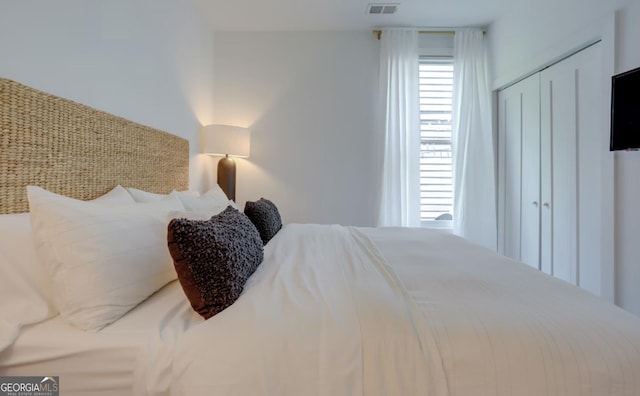 bedroom featuring visible vents and a closet