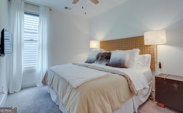 bedroom featuring carpet flooring, a ceiling fan, and visible vents