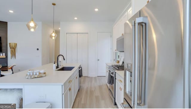 kitchen featuring a sink, light countertops, white cabinetry, and stainless steel appliances