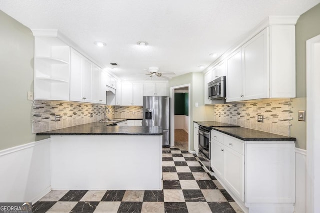 kitchen with open shelves, dark countertops, appliances with stainless steel finishes, a peninsula, and ceiling fan