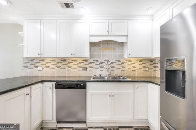 kitchen featuring white cabinetry, stainless steel appliances, and a sink