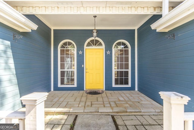 view of exterior entry with covered porch