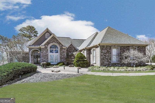 view of front of house with brick siding and a front yard